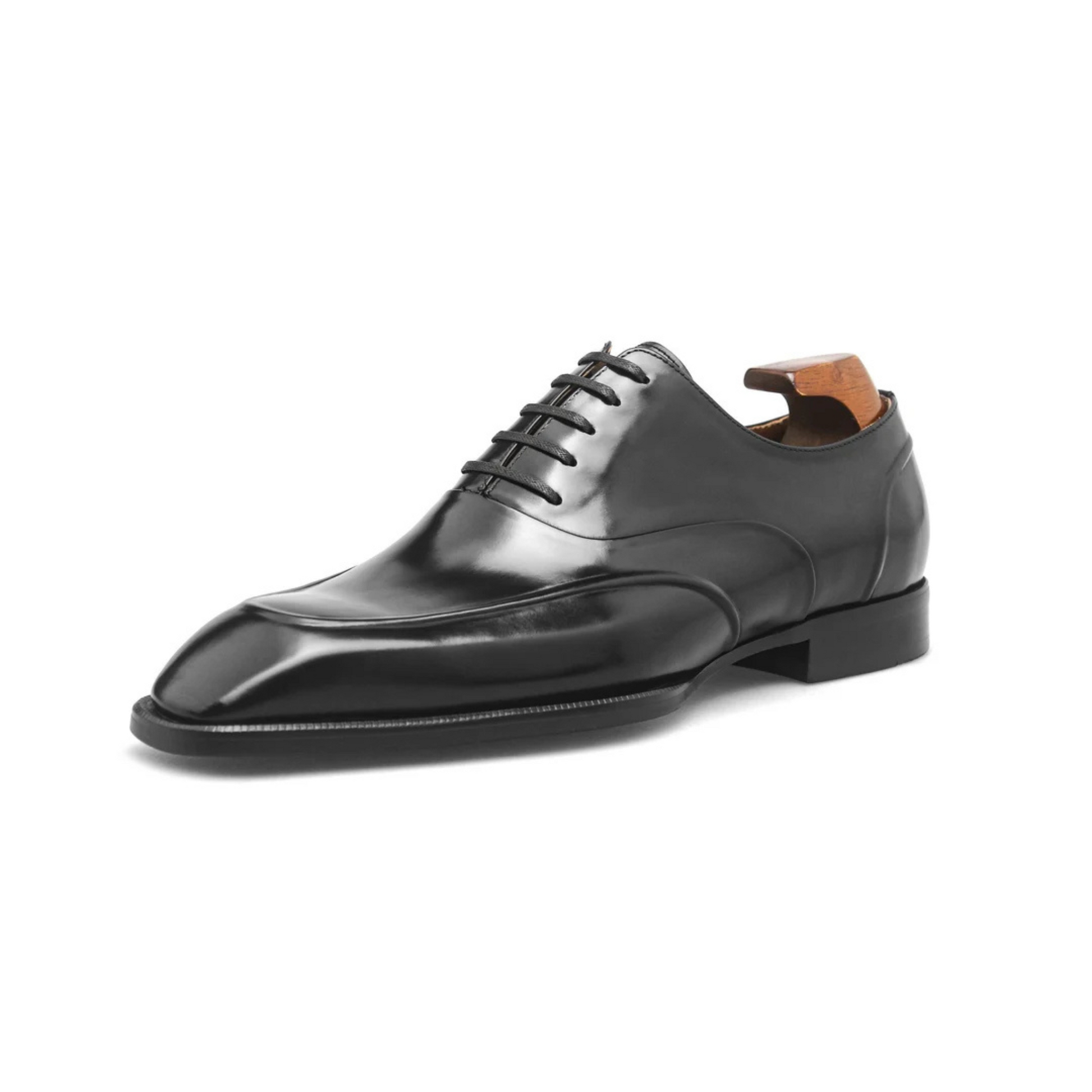 Close-up of Black Wholecut Oxford Shoes, showing intricate detailing, sleek high-gloss leather finish, and elegant design.