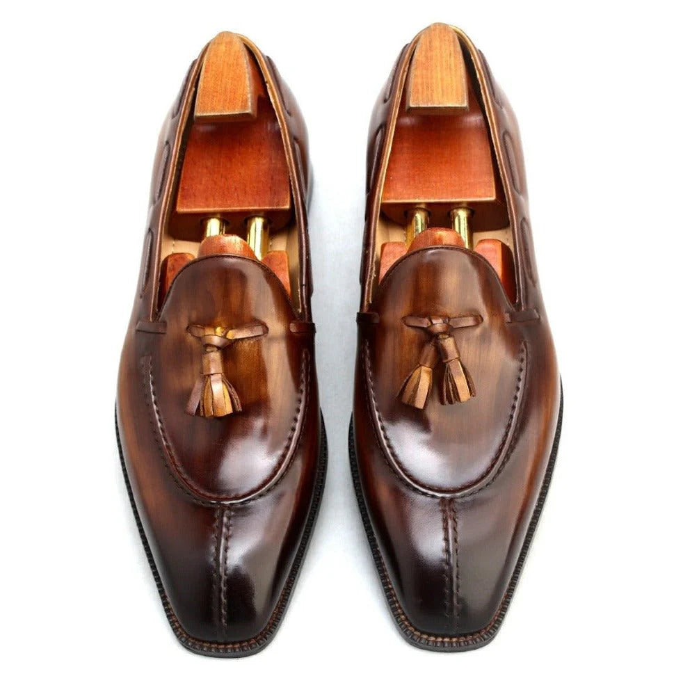 Top view of Brown Patina Leather Tassel Loafers, showcasing the polished finish, elegant tassel detailing, and wooden shoe trees for preservation.