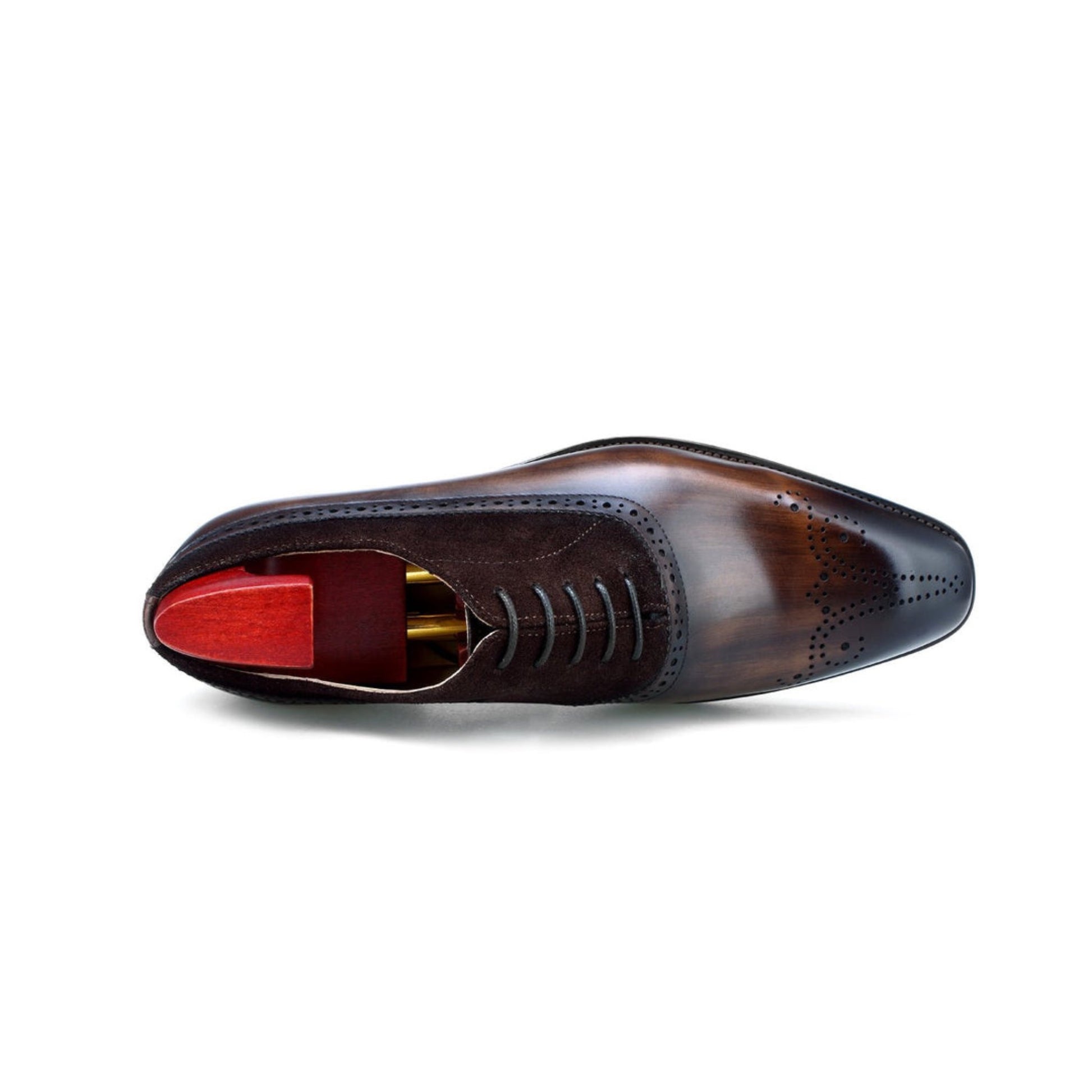 Top-down view of brown leather oxford shoes with suede accents and wooden shoe trees, highlighting a polished and refined style.