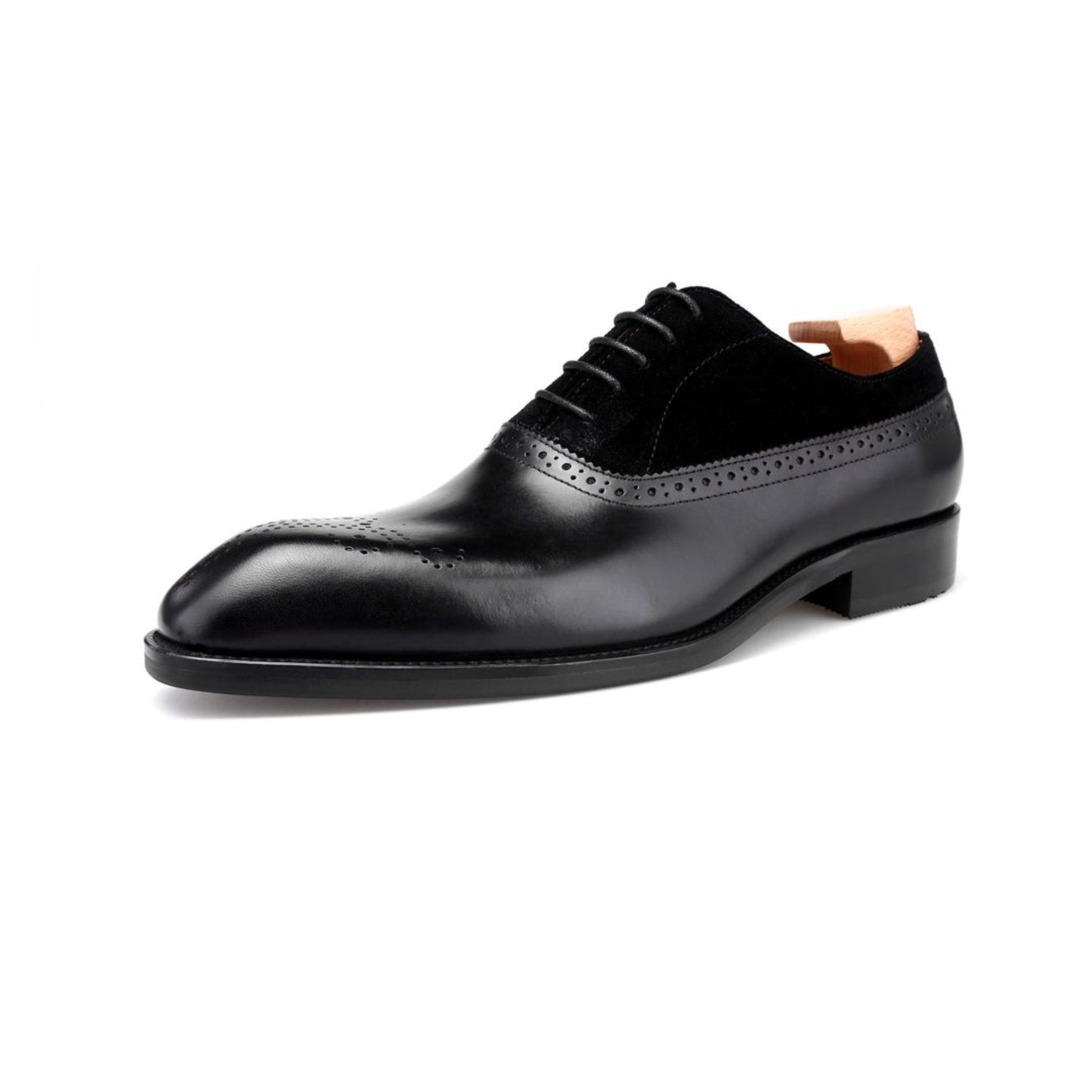 Side view of black leather oxford shoes with suede detailing, featuring fine brogue patterns and sleek design.